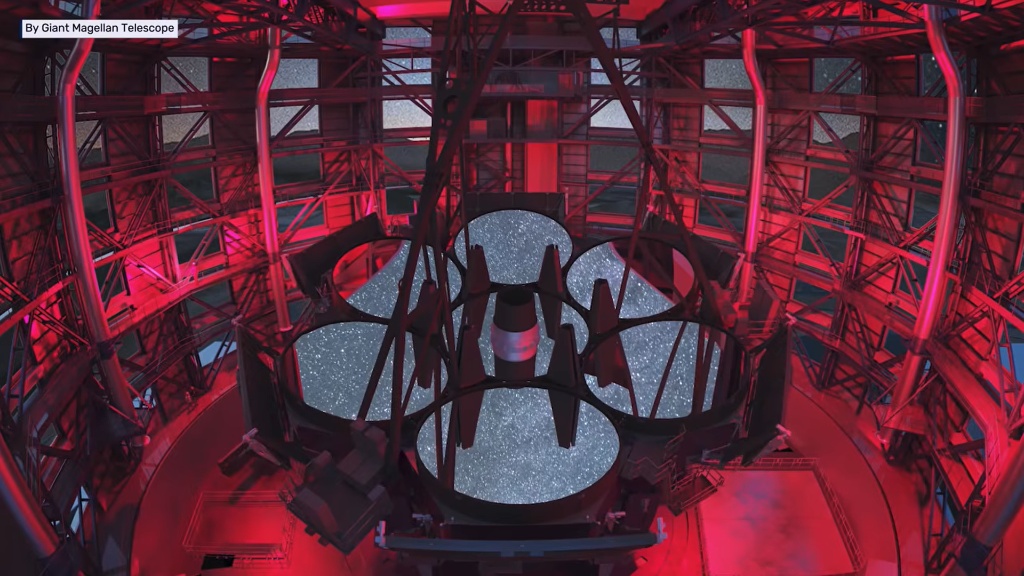 Estrutura interna do GMT iluminada em vermelho mostrando os espelhos primários